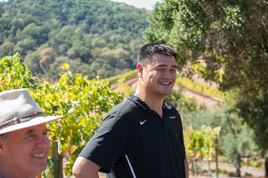 Image: Yao Ming in the vineyards of one of his Cabernet Sauvignon growers with Jay Bemke, a board member for Yao Family Wines. Credit: Avis Mandel, for Yao Family Wines