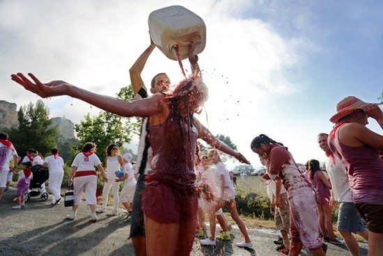 Image: A man pours red wine on a girl during the"Batalla del Vino" (Battle of Wine Festival) in Haro, on June 29, 2015. Credit: CESAR MANSO/AFP/Getty Images