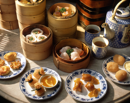 Steamers and plates of dim sum with tea, China, Asia. Credit: robertharding / Alamy Stock Photo